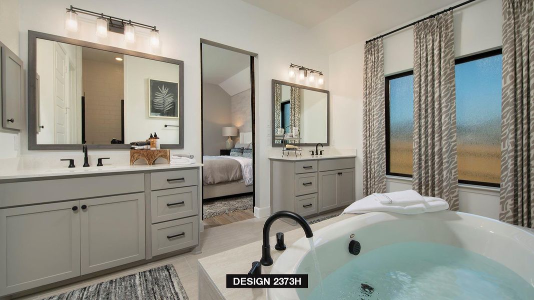 Bathroom featuring two vanities and a garden tub Bathroom featuring two vanities and a garden tub