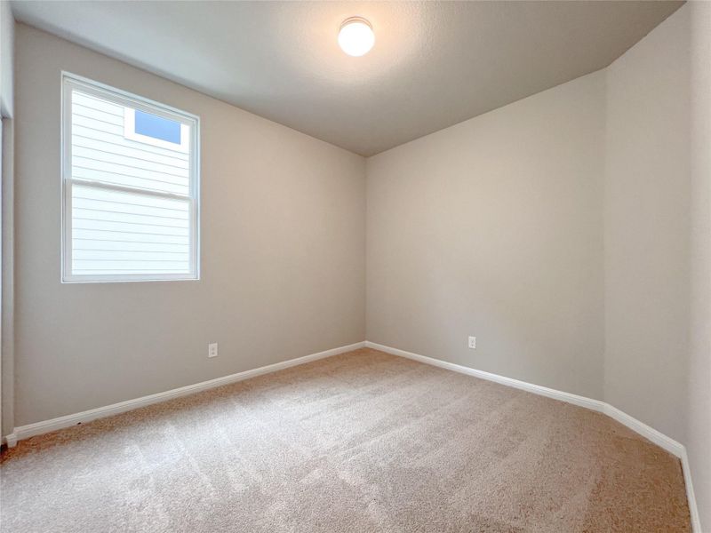 Well-lit sleeping quarters with a broad window and comfortable carpeting. Well-lit sleeping quarters with a broad window and comfortable carpeting.