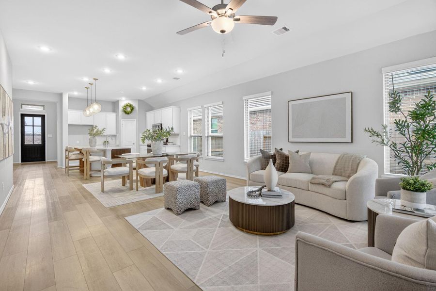 This photo showcases a bright, open-concept living and dining area with modern decor. The kitchen is visible in the background, enhancing the spacious feel. This photo showcases a bright, open-concept living and dining area with modern decor. The kitchen is visible in the background, enhancing the spacious feel.