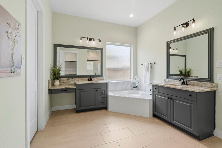 The Primary Bath exudes sophistication and timeless style, offering a beautifully designed retreat for daily relaxation. Thoughtfully appointed with dual vanities, a dedicated makeup vanity, elegant granite countertops, and framed mirrors, every detail has been carefully curated to blend luxury with functionality. The result is a refined and inviting space that elevates everyday routines into a spa-like experience.