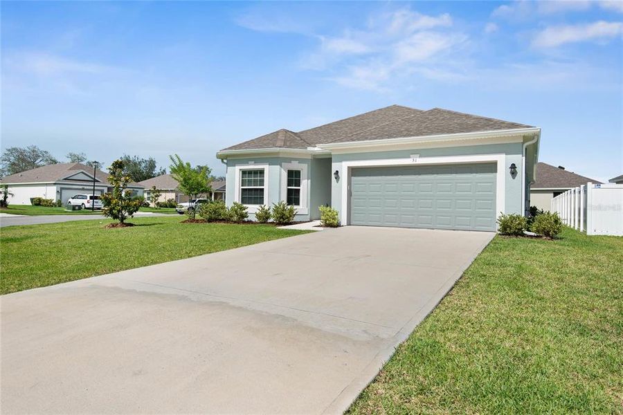 Front exterior of a new home in Sawmill Creek at Palm Coast Park, Palm Coast, FL, highlighting curb appeal (Image 28). Front exterior of a new home in Sawmill Creek at Palm Coast Park, Palm Coast, FL, highlighting curb appeal (Image 28).