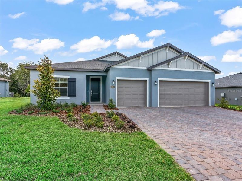 Front exterior of a new home in Juliette Falls, Dunnellon, FL, highlighting curb appeal (Image 24).