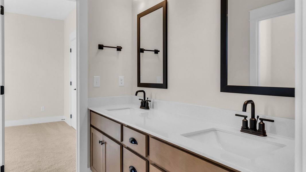 Secondary bathroom with dual sink vanity (Representative of finished home)
