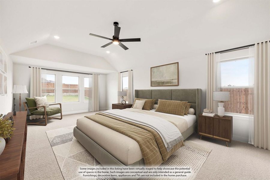 Spacious master bedroom with vaulted ceiling, ceiling fan, carpet flooring, and multiple windows
