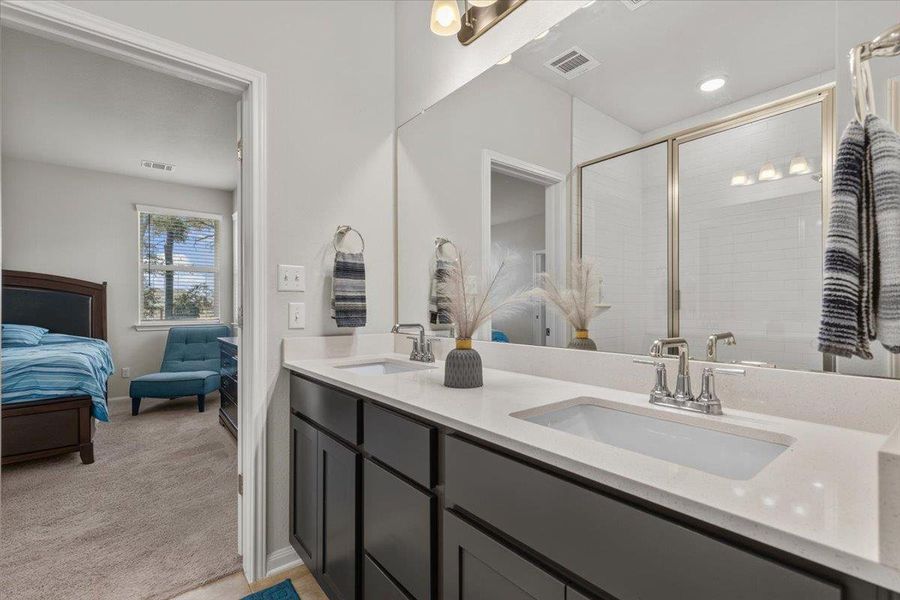 Clean lines and a double vanity define this contemporary master bathroom.