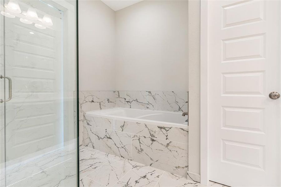 The master bathroom also comes with a standing shower with white subway tile throughout!