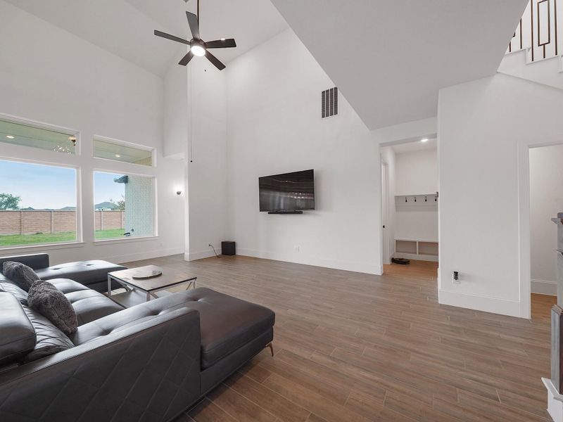 With soaring ceilings and open sight lines, the living room is the true centerpiece of the home. Oversized windows bring in sunlight, while the spacious design offers plenty of room for both relaxation and entertaining.