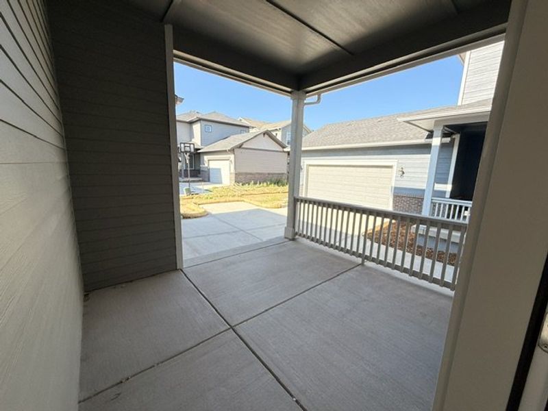 Exterior details and patio area of a home in Painted Prairie Cottage Collection, Aurora (Image 3).