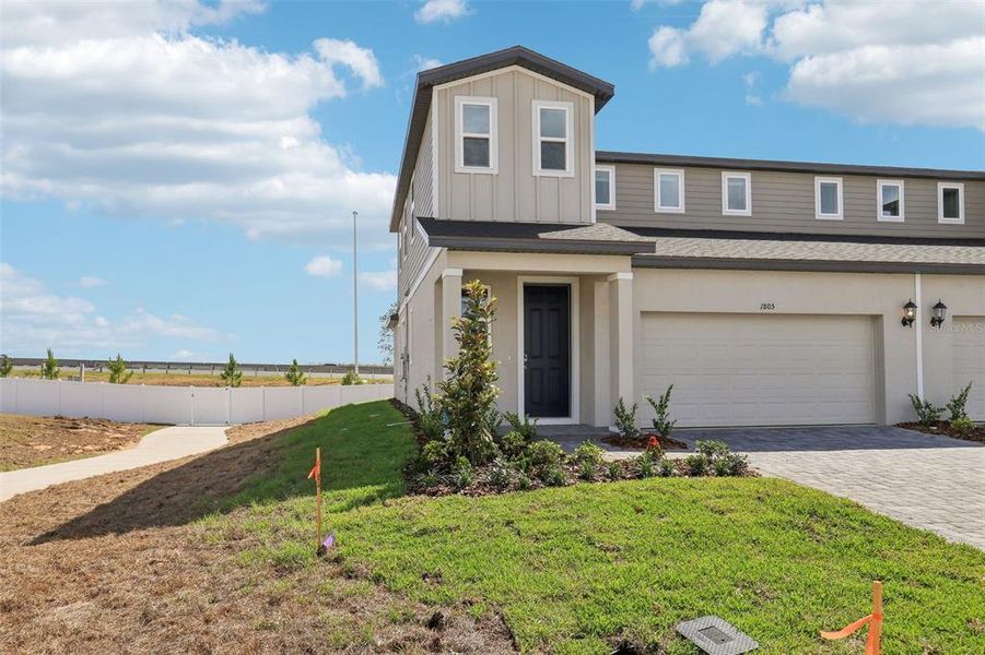 Front exterior of a new home in Cyrene at Minneola - Villas, Minneola, FL, highlighting curb appeal (Image 18).