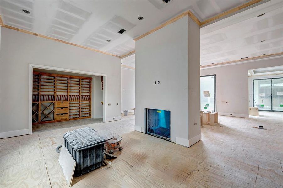 On the other side of the the two-sided fireplace is the wine room and flexible space. Not pictured is the wet bar. Stage of construction as of April 3, 2025. On the other side of the the two-sided fireplace is the wine room and flexible space. Not pictured is the wet bar. Stage of construction as of April 3, 2025.