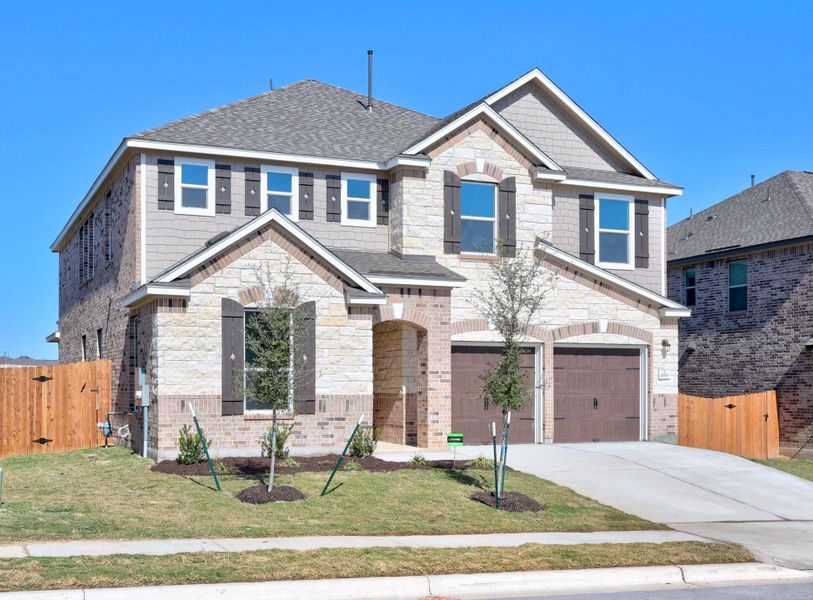 Front exterior of a new home in Salerno - Classic Collection, Round Rock, TX, highlighting curb appeal (Image 1).