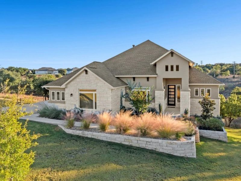 View of front of house featuring a front lawn, roof with shingles, stone siding, and stucco siding View of front of house featuring a front lawn, roof with shingles, stone siding, and stucco siding