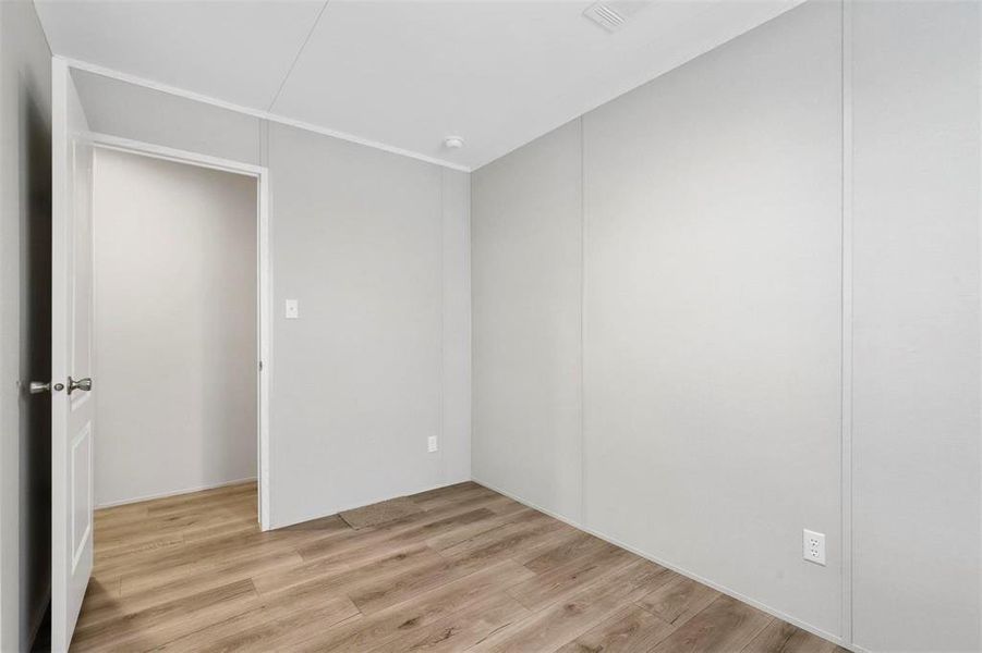 Empty room featuring light wood-type flooring