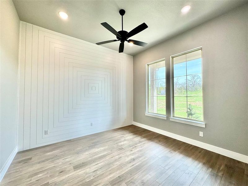 Unfurnished room featuring wood finished floors, baseboards, a ceiling fan, and recessed lighting