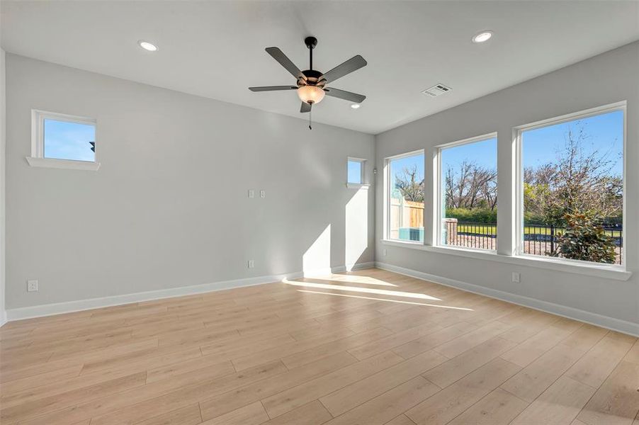 Unfurnished room featuring light wood-style flooring, ceiling fan, and recessed lighting Unfurnished room featuring light wood-style flooring, ceiling fan, and recessed lighting