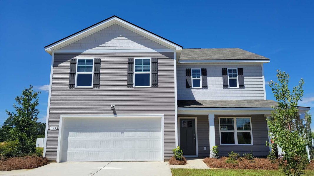 Front exterior of a new home in Heritage Crossing, Conway, SC, highlighting curb appeal (Image 1).