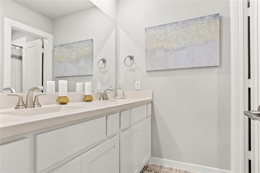 Bathroom with double vanity and tile flooring