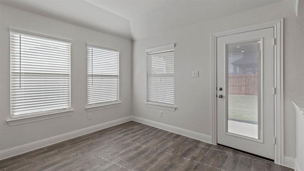 Doorway featuring wood tiled floors and baseboards