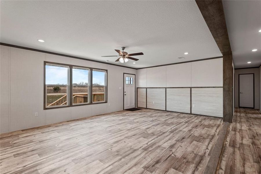 Unfurnished bedroom with crown molding, light wood finished floors, ceiling fan, recessed lighting, and a textured ceiling