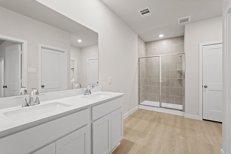 A bathroom with white cabinets. A bathroom with white cabinets.