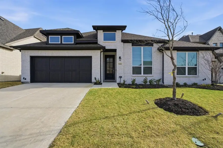 Front exterior of a new home in Gideon Grove, Rockwall, TX, highlighting curb appeal (Image 2). Front exterior of a new home in Gideon Grove, Rockwall, TX, highlighting curb appeal (Image 2).