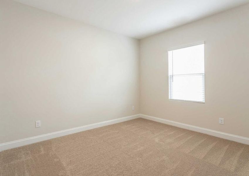 Burton bedroom with window, brown carpet, and off white painted walls