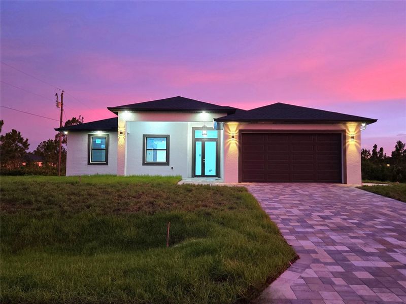 Front exterior of a new home in , Lehigh Acres, FL, highlighting curb appeal (Image 1).
