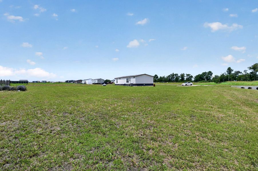 A sprawling lot offers ample space, hinting at rural living.