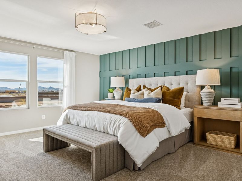 A bedroom with a bed and a bench. A bedroom with a bed and a bench.
