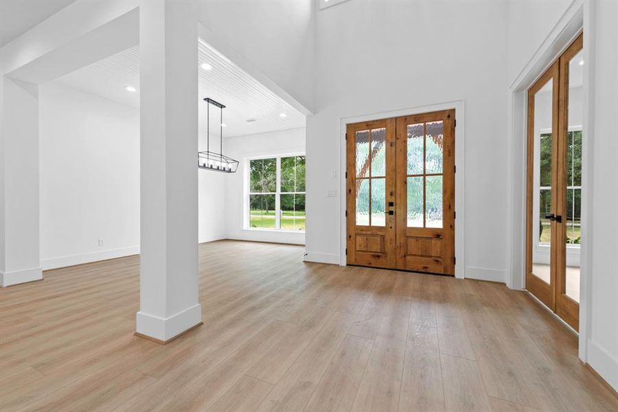 Two story double door entry to home.