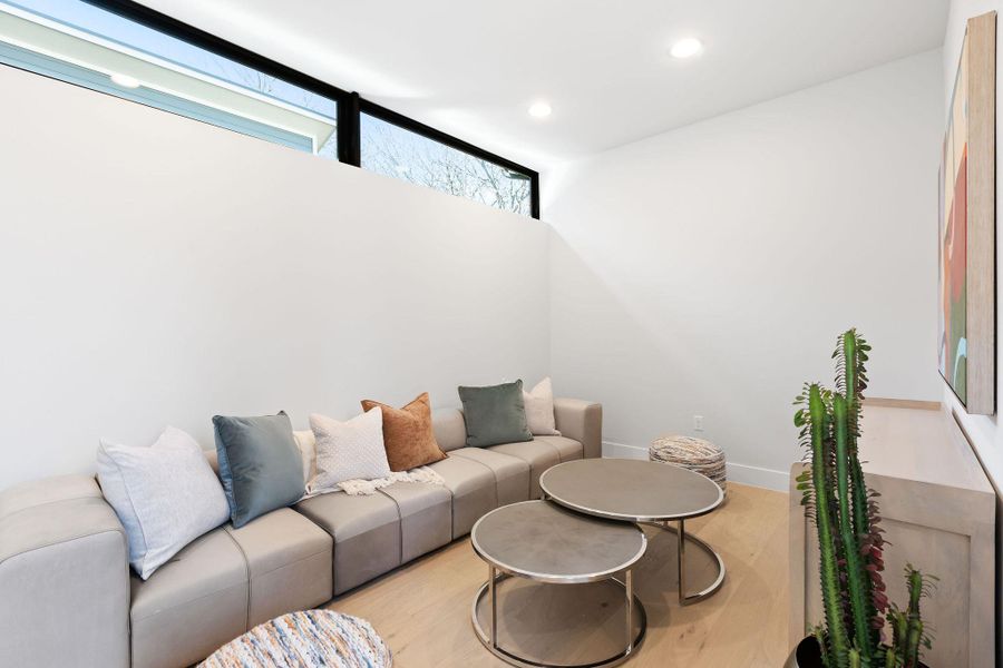 Living room featuring light wood-style flooring, recessed lighting, and baseboards