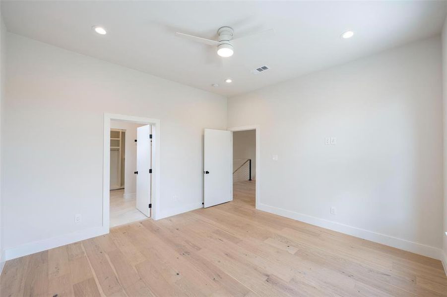 Unfurnished room featuring ceiling fan and light hardwood / wood-style flooring Unfurnished room featuring ceiling fan and light hardwood / wood-style flooring