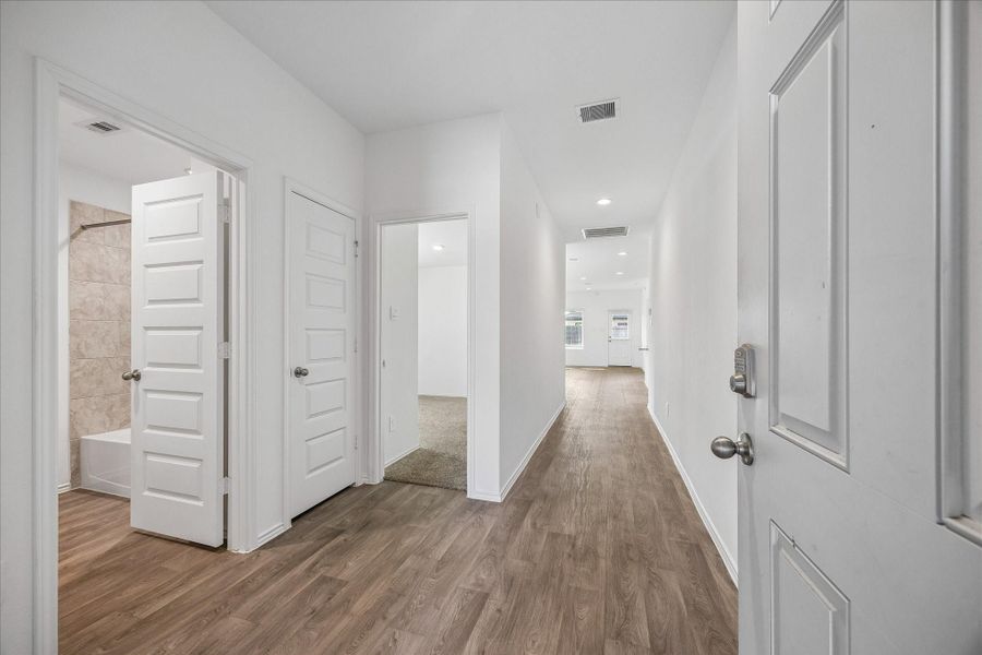 Entryway with wood-like flooring leading to a functional open-concept layout perfect for everyday living and entertaining