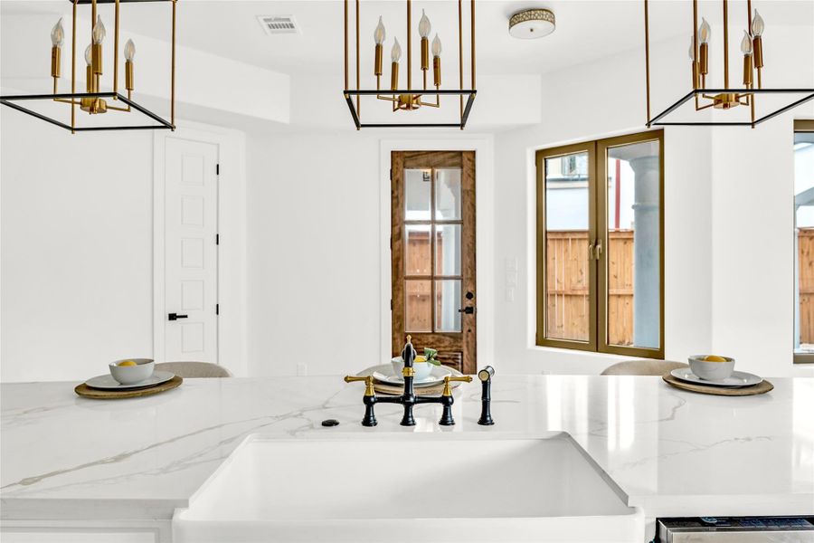 The two-toned bridge faucet pairs beautifully with the classic fireclay apron-front sink. The two-toned bridge faucet pairs beautifully with the classic fireclay apron-front sink.