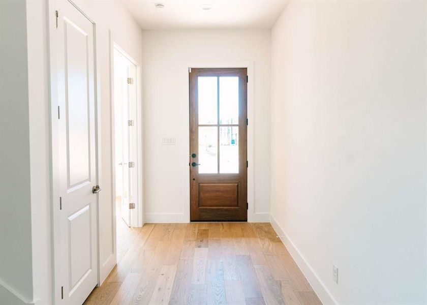 Doorway to outside with light hardwood / wood-style floors