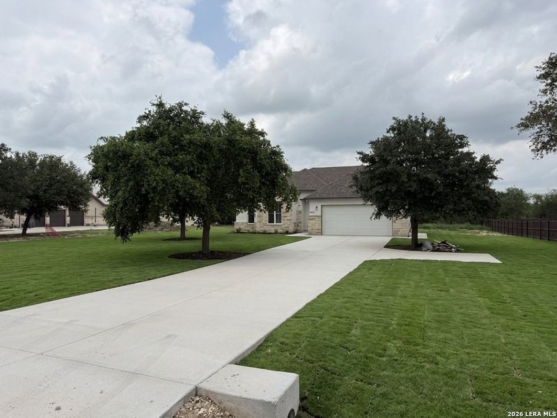 Front exterior of a new home in , Lytle, TX, highlighting curb appeal (Image 27).