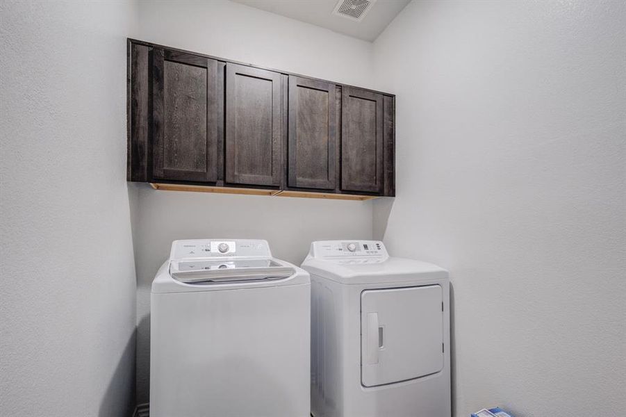 Laundry area featuring cabinet space and independent washer and dryer Laundry area featuring cabinet space and independent washer and dryer