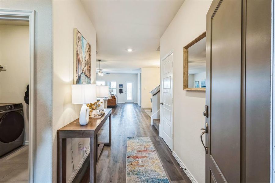 Hallway featuring washer / clothes dryer and dark wood-type flooring