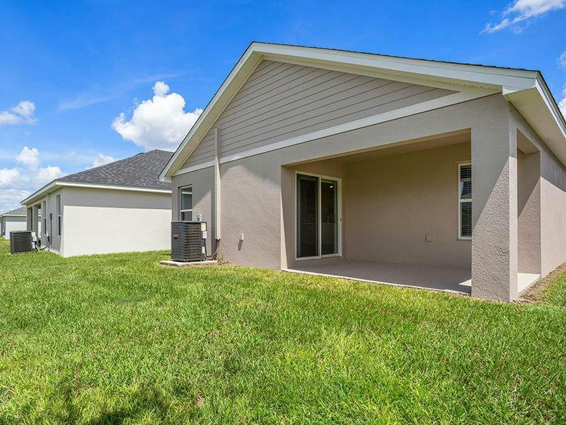 Your living area opens to a covered lanai and a nice-sized backyard.