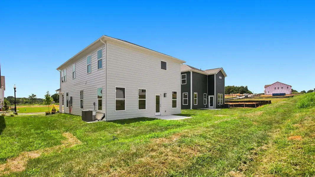 Angled view of spacious two-story home from backyard Angled view of spacious two-story home from backyard