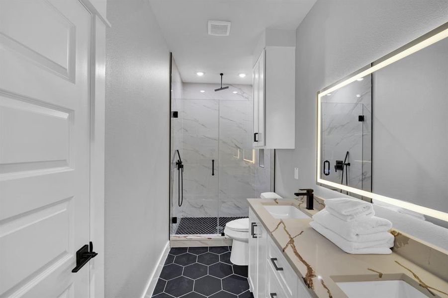 Luxurious master bathroom with high-end features.