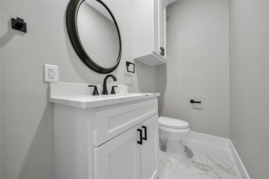 Bathroom with vanity, tile patterned flooring, and toilet