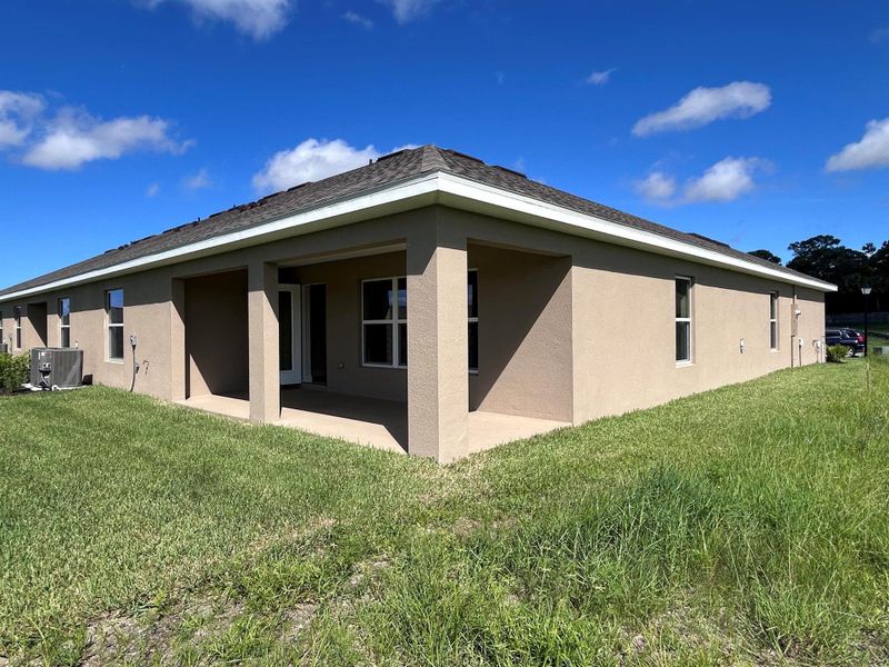Front exterior of a new home in Waterstone Villas, Fort Pierce, FL, highlighting curb appeal (Image 2). Front exterior of a new home in Waterstone Villas, Fort Pierce, FL, highlighting curb appeal (Image 2).