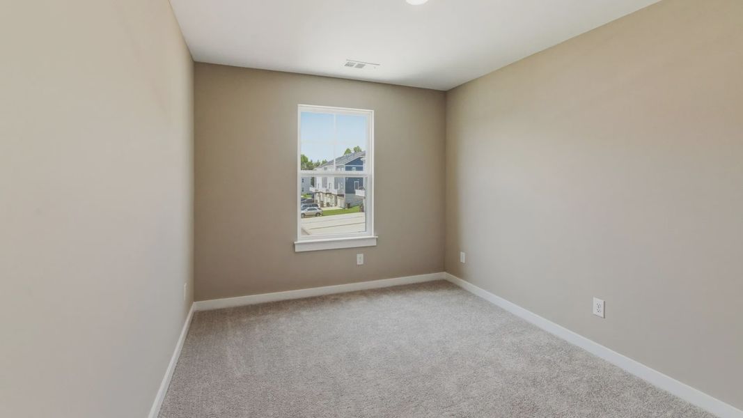 Bedroom with carpet and window