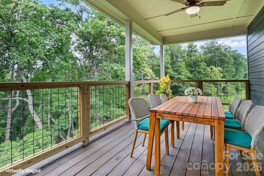 Virtually staged trex deck off main living area with dual ceiling fans.
