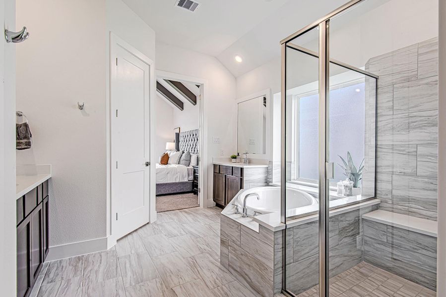 Beautifully tiled and thoughtfully designed, the walk-in shower features a built-in bench and glass enclosure for a clean, elevated look. Beautifully tiled and thoughtfully designed, the walk-in shower features a built-in bench and glass enclosure for a clean, elevated look.