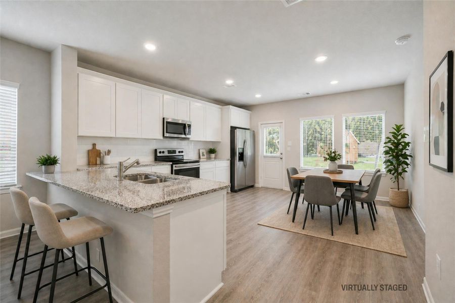 Virtually staged photo of breakfast bar and kitchen