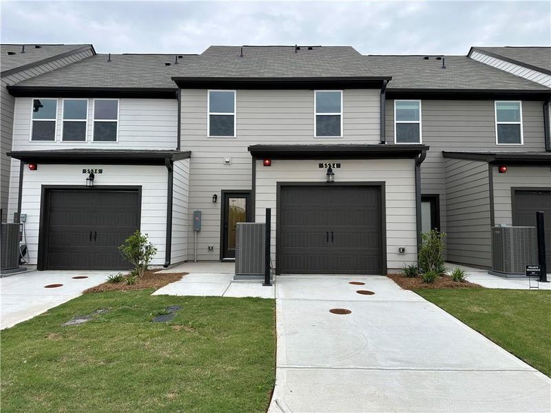 Front exterior of a new home in Laurelwood, Douglasville, GA, highlighting curb appeal (Image 15).