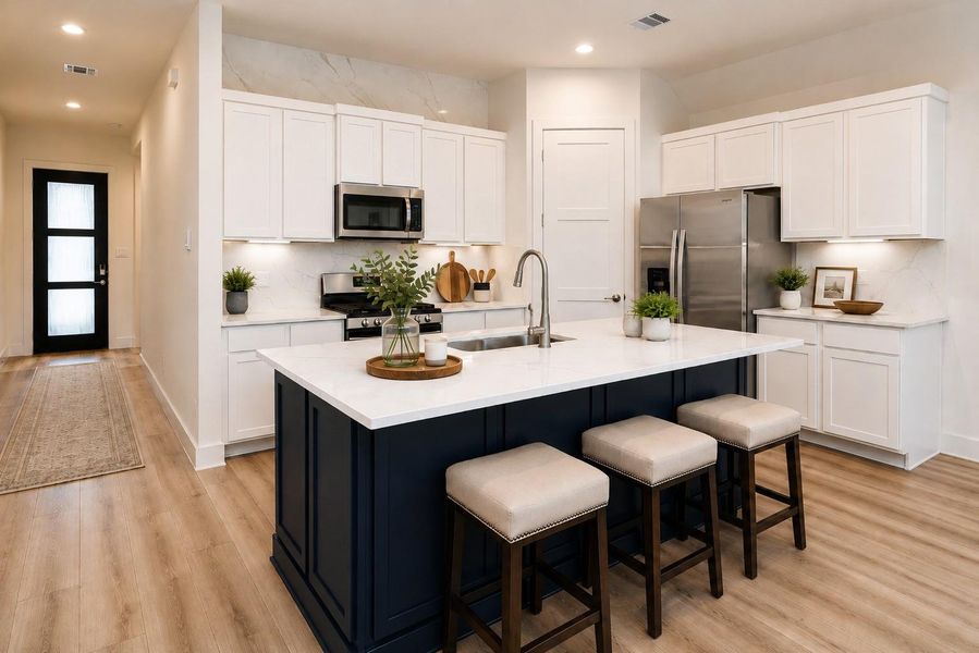 The navy statement island anchors the kitchen, surrounded by crisp white cabinetry and Calacatta Gold quartz carried all the way up the backsplash for a bold, polished finish. *virtually staged*