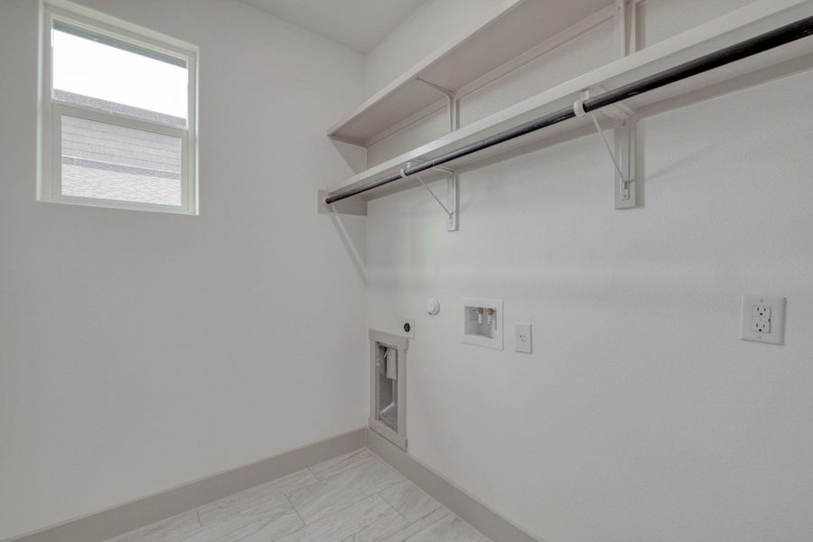 Laundry room with hookup for a gas dryer, washer hookup, and hookup for an electric dryer Laundry room with hookup for a gas dryer, washer hookup, and hookup for an electric dryer